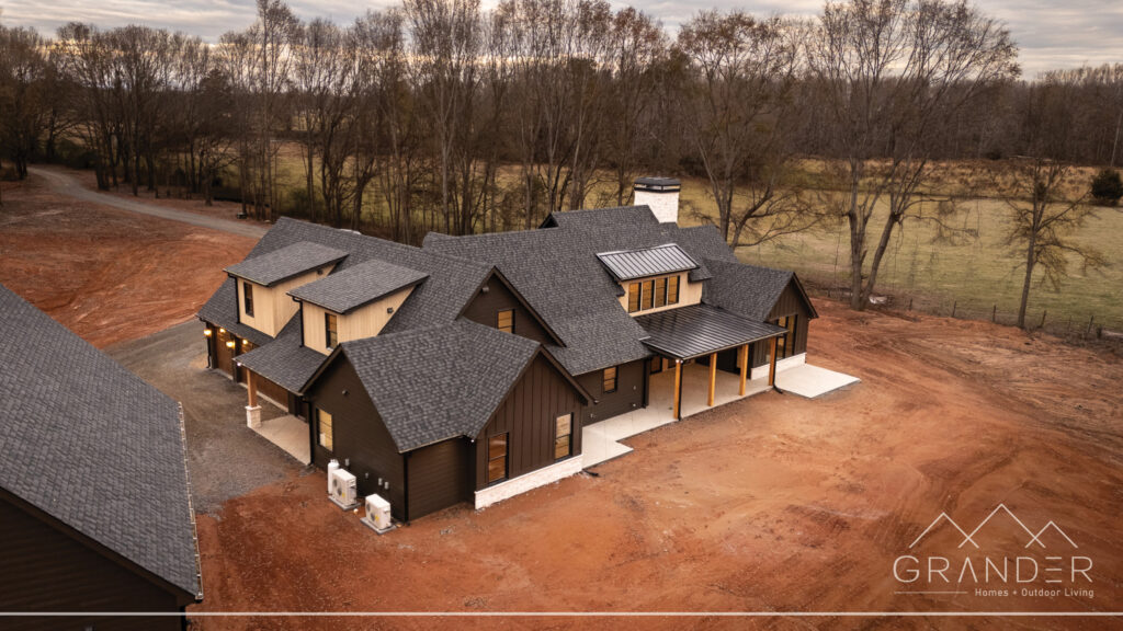 custom home exterior featuring covered porch, roofline detail, custom exterior craftsmanship in greer, south carolina