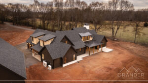 custom home exterior featuring covered porch, roofline detail, custom exterior craftsmanship in greer, south carolina