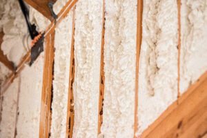 spray foam insulation installed between roof framing members in custom home construction