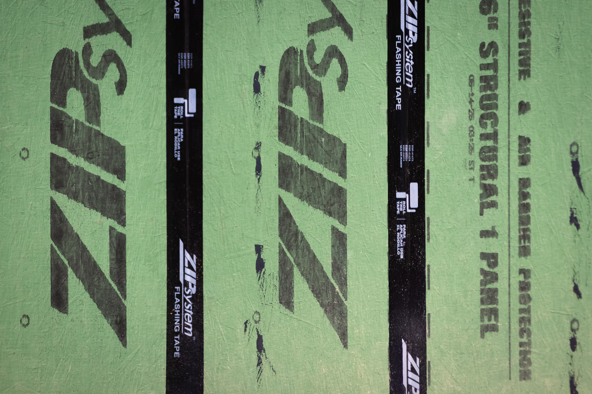 Close-up of ZIP System structural sheathing tape creating continuous air barrier